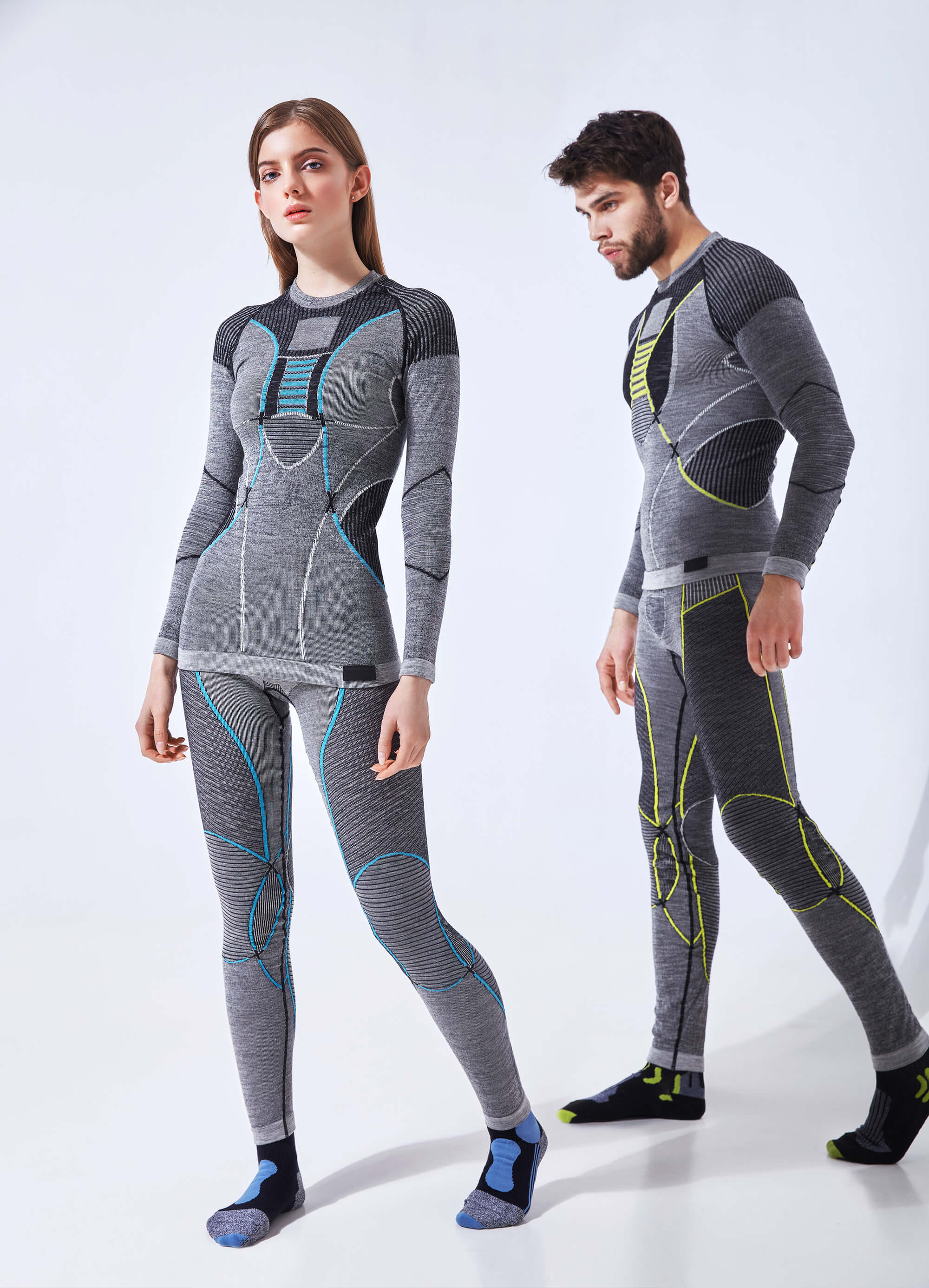A man and a woman wearing thermal underwear and socks