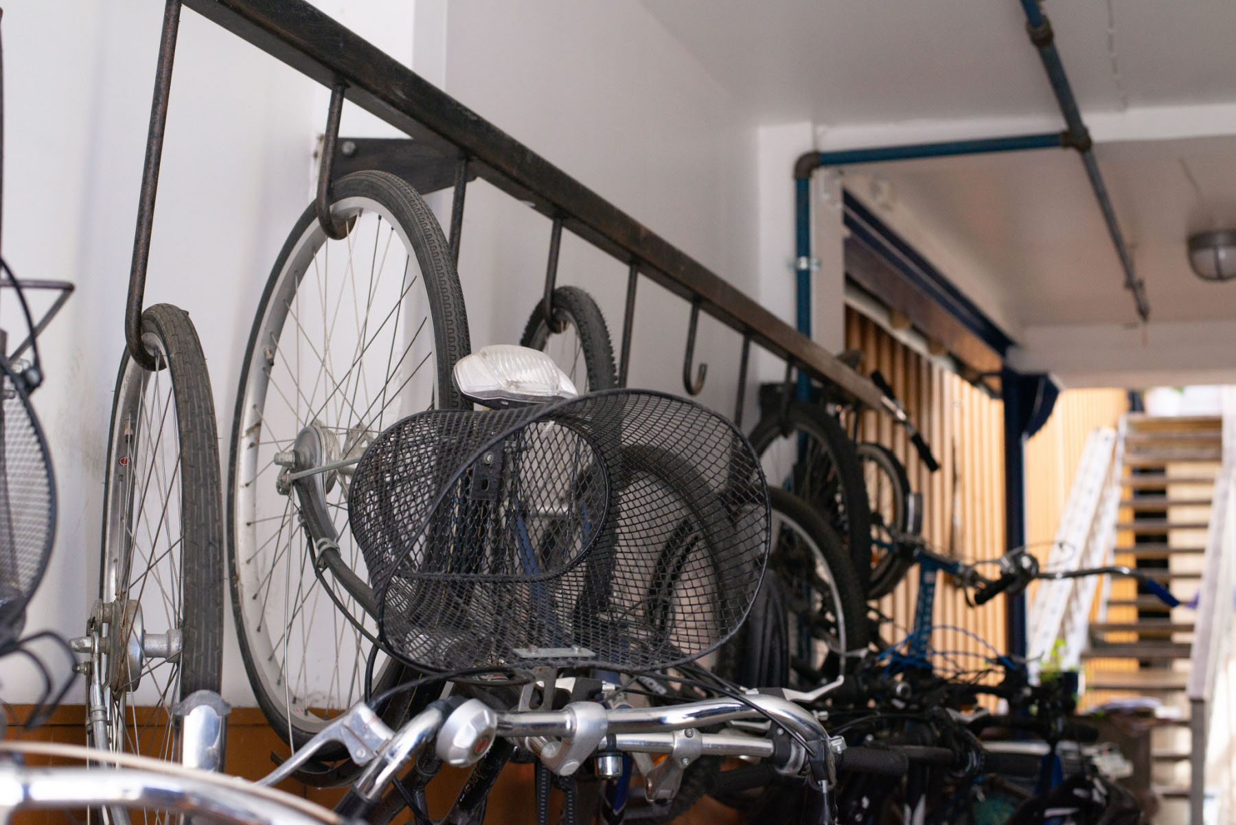 Stored bicycles hung by the front wheel