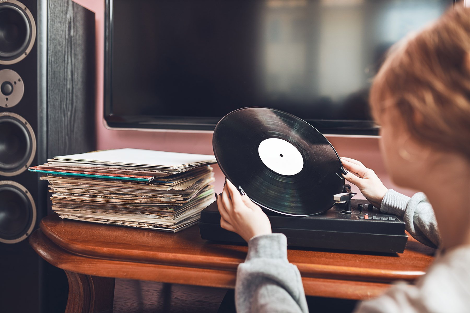 a woman holding a gramophone record