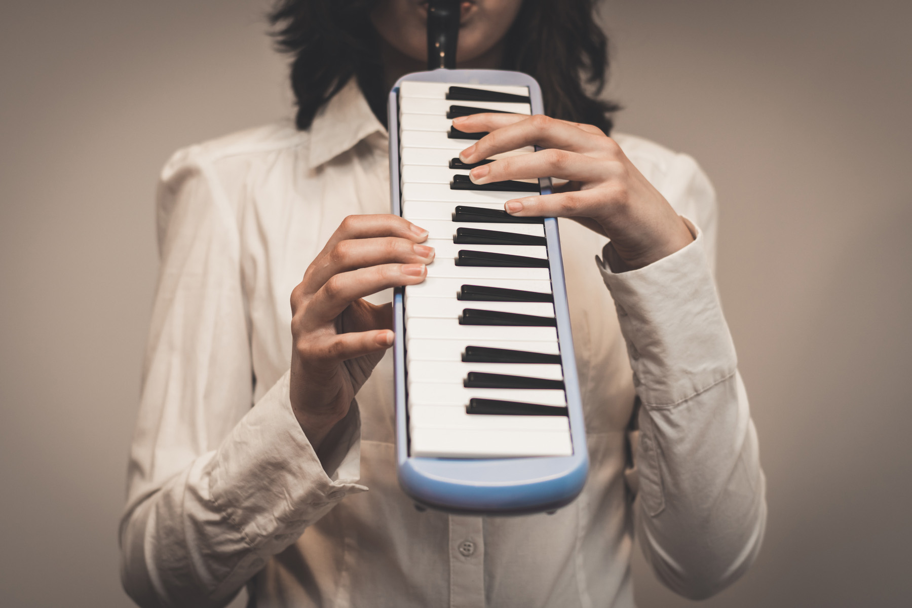 a woman playing the melodica